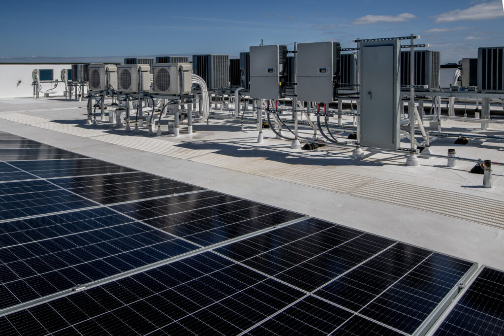 Rooftop air conditioners with heat pumps and solar panels.